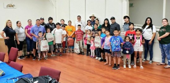 Assemblymember Rudy Salas hosted a backpack and shoe giveaway in Avenal. Here, he's show with students and friends.